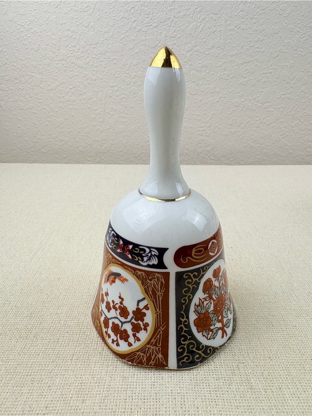Decorative White and Gold Porcelain Dinner Bell Featuring Floral Motif